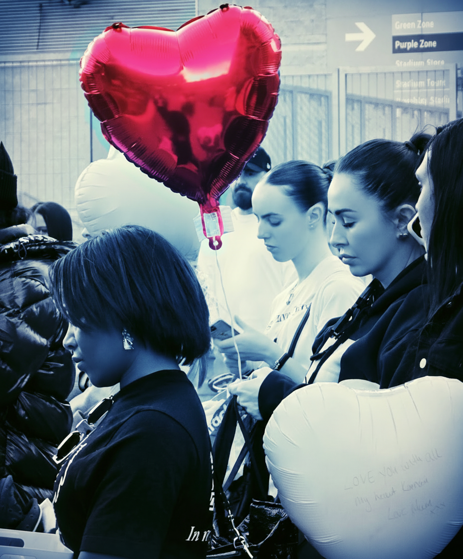 Community members holding a red heart balloon in memory of those lost to violence